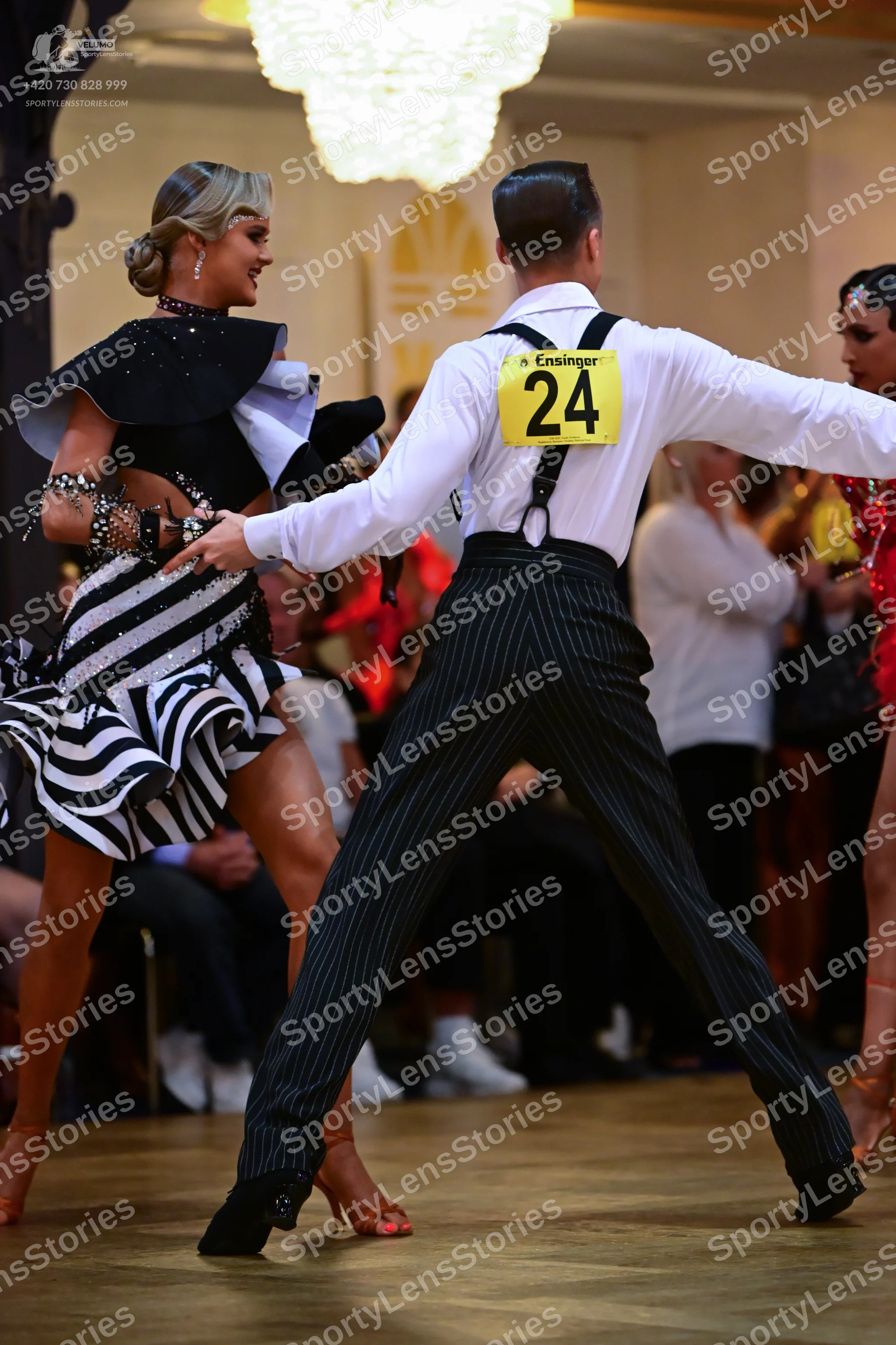 Dancesport competitor #24: Male dancer: white long-sleeved shirt, black pinstriped trousers, and black susp