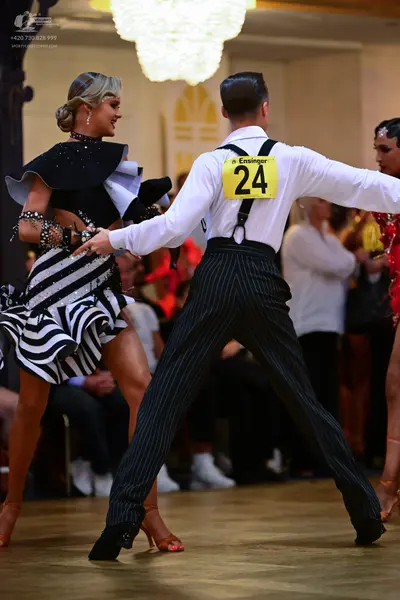 Dancesport competitor #24: Male dancer: white long-sleeved shirt, black pinstriped trousers, and black susp