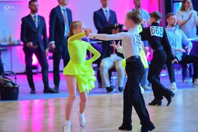Dancesport competitor #392, #668: Male dancer 1: white long-sleeved shirt and black trousers