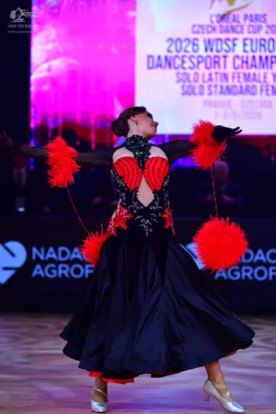 Dancesport competitor: Female dancer: black and red ballgown with a voluminous black satin skirt featur