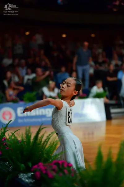 Dancesport competitor: Female dancer: white ballroom dress