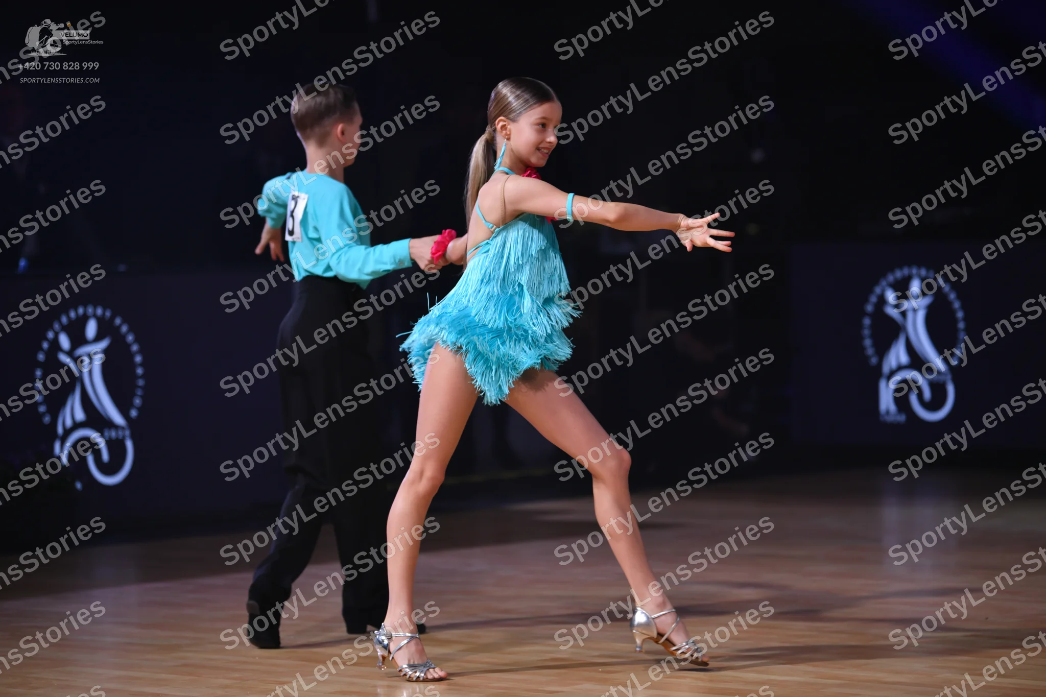 Dancesport competitor: Male dancer: light blue long-sleeved shirt and black trousers