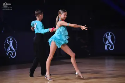 Dancesport competitor: Male dancer: light blue long-sleeved shirt and black trousers