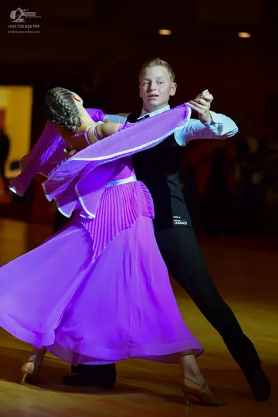 Dancesport competitor: Male dancer: white long-sleeved shirt, black waistcoat, and black trousers
