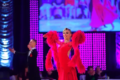 Dancesport competitor: Male dancer: black suit with a white shirt and red bow tie