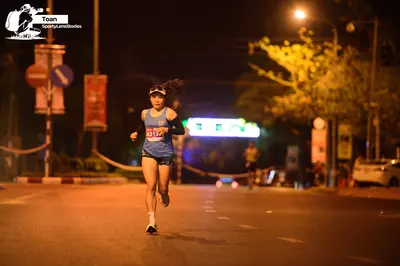 Marathon runner #F10559: Runner 1: light blue tank top, navy shorts, white socks, black and white running