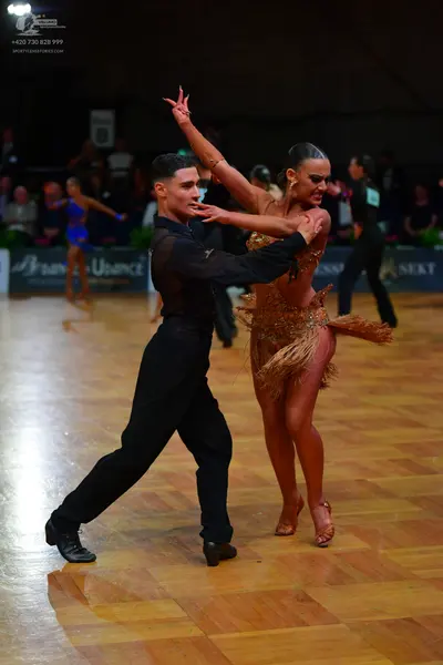 Dancesport competitor: Male dancer: black long-sleeved shirt with mesh details and black trousers