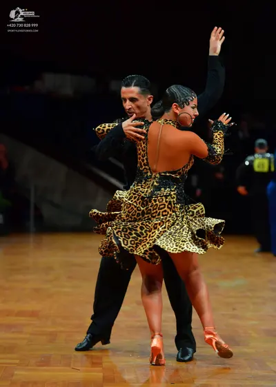 Dancesport competitor: Male dancer: black long-sleeved top and black trousers
