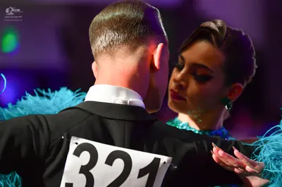 Dancesport competitor #321: Male dancer: black suit jacket with a white shirt collar