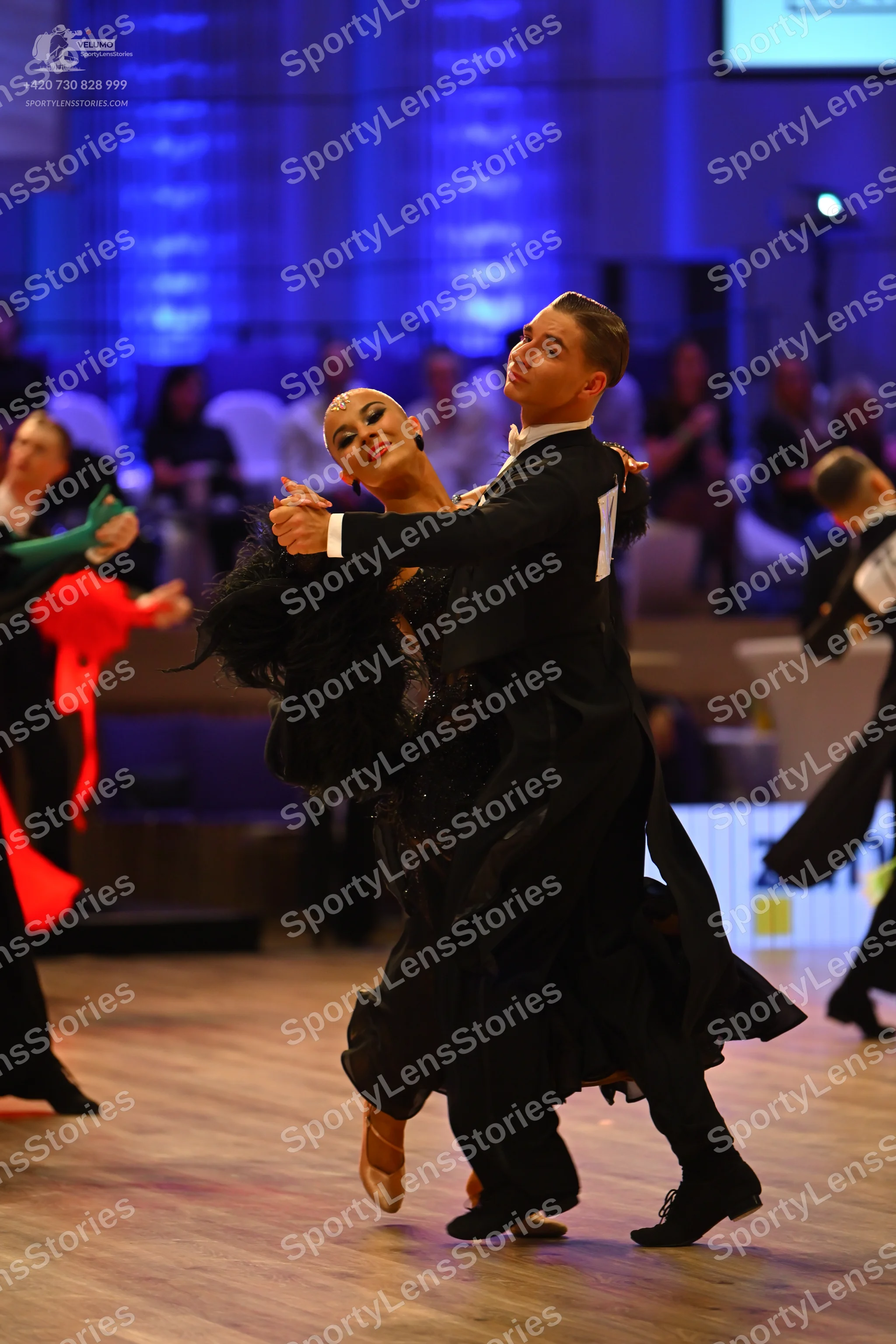 Dancesport competitor: Male dancer: black ballroom suit with a white shirt, black trousers, and black d