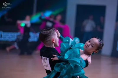 Dancesport competitor: Male dancer: black long-sleeved top
