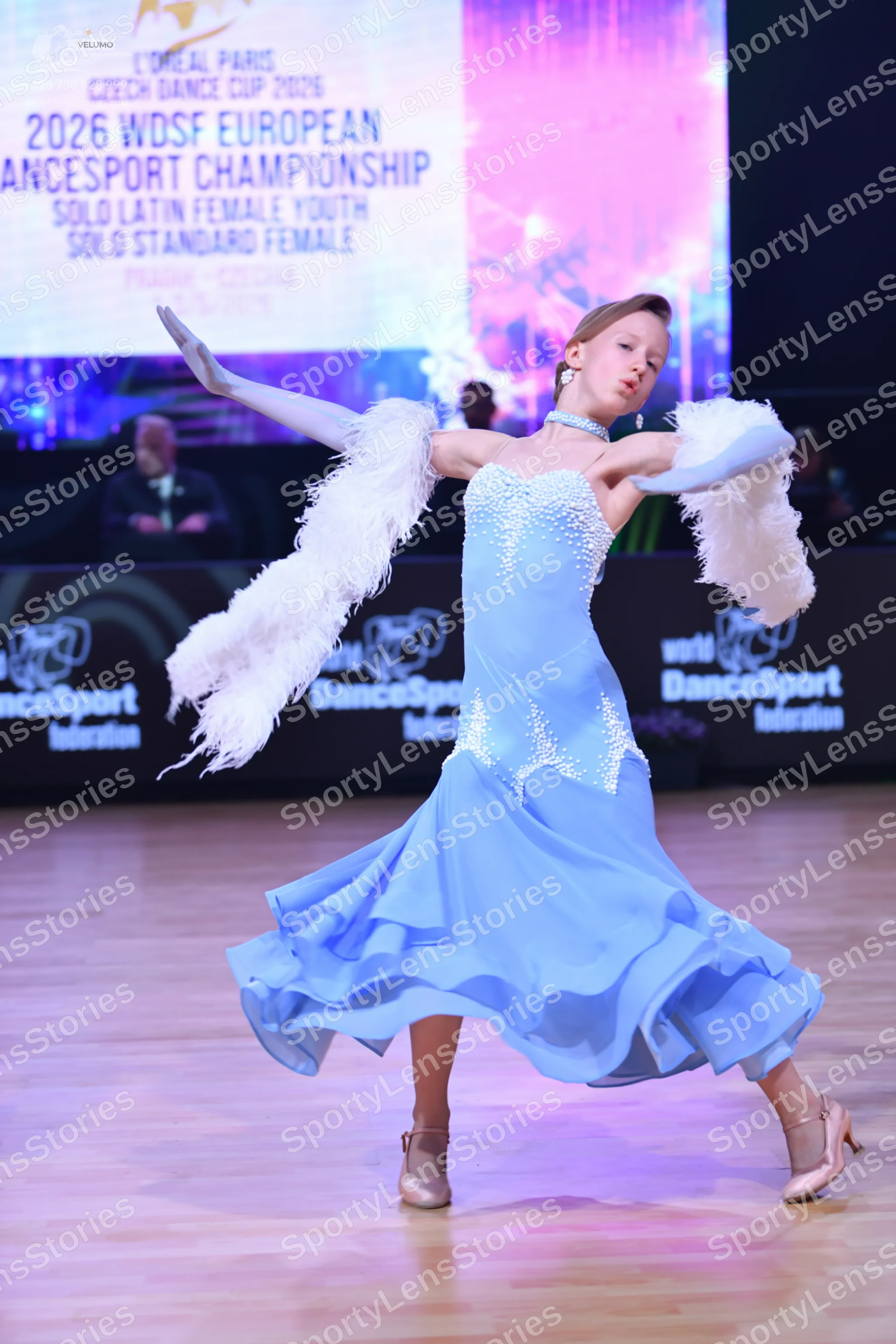 Dancesport competitor: Female dancer: light blue ballroom dress with white sequin/lace embellishments o