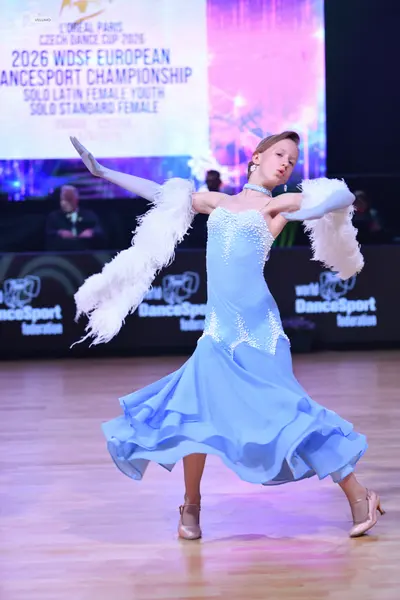 Dancesport competitor: Female dancer: light blue ballroom dress with white sequin/lace embellishments o