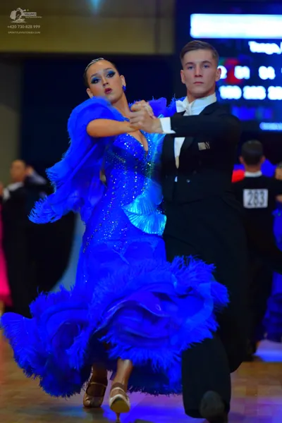 Dancesport competitor #283: Female dancer: blue ballroom dress with sequins and large voluminous ruffled lay