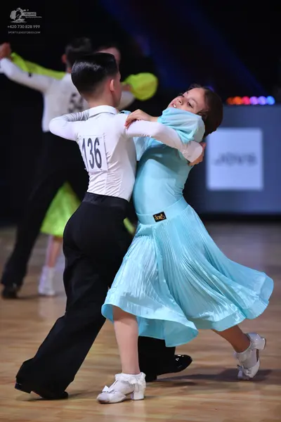 Dancesport competitor: Male dancer: white long-sleeved shirt and black trousers