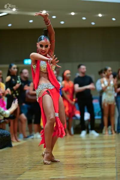 Dancesport competitor: Main female dancer: red two-piece Latin dress with silver sequins and crystals, 