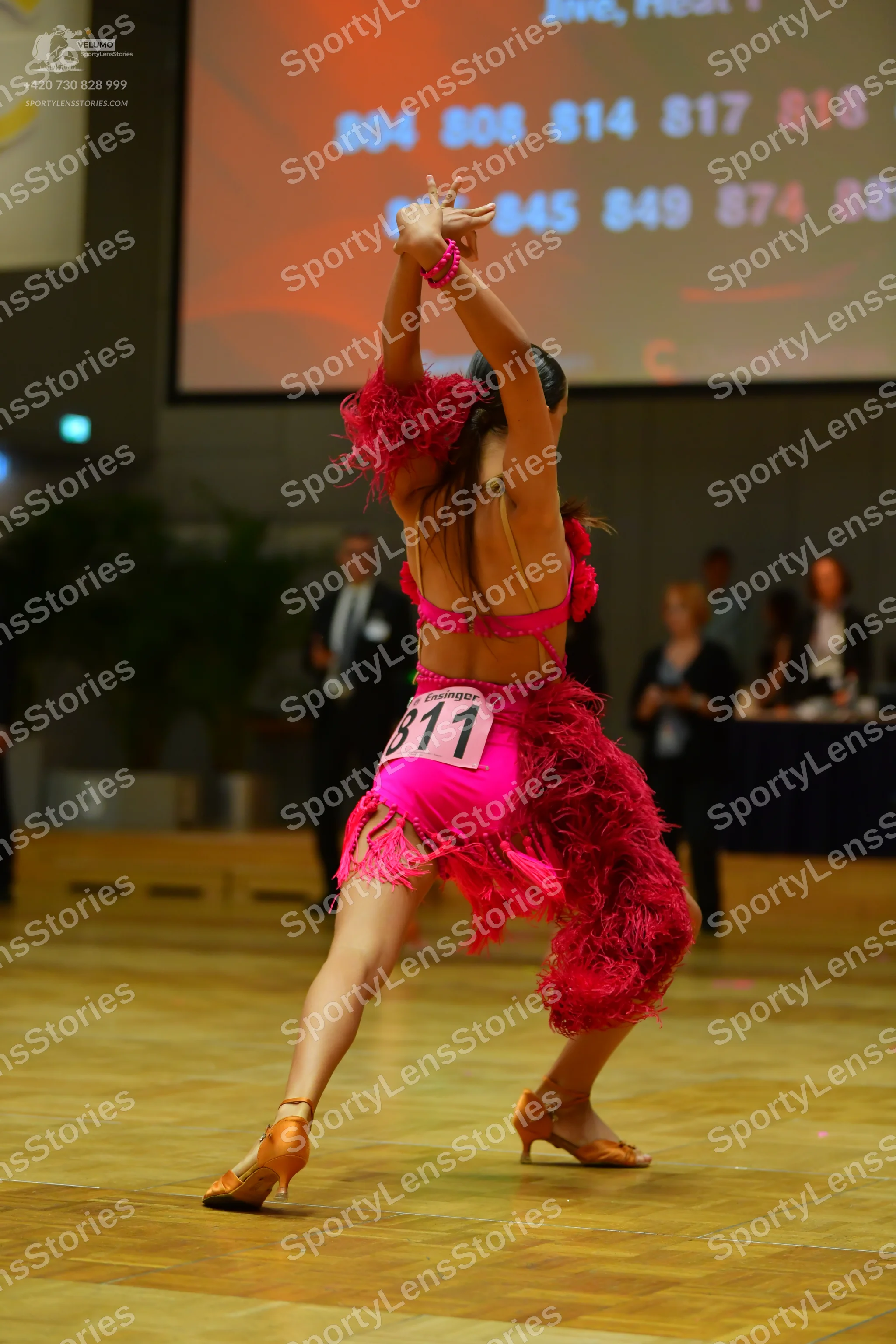 Dancesport competitor #811: Female dancer: pink Latin dress with long fringe
