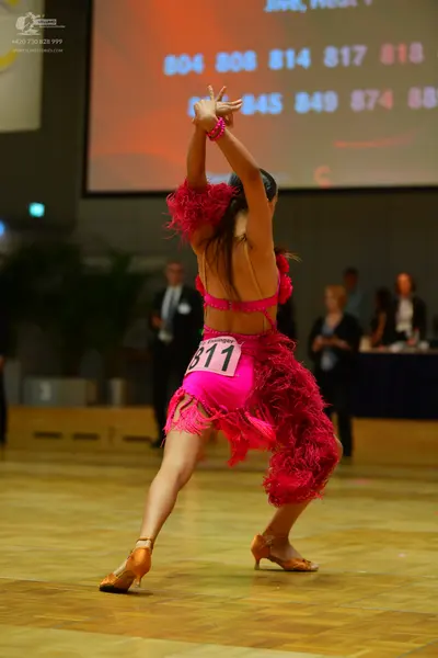 Dancesport competitor #811: Female dancer: pink Latin dress with long fringe