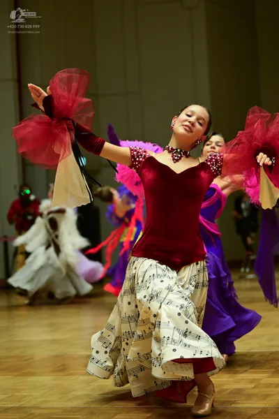 Dancesport competitor: ** Red latin dress with fringe
*   **Fabric:** Likely satin or a similar smooth 