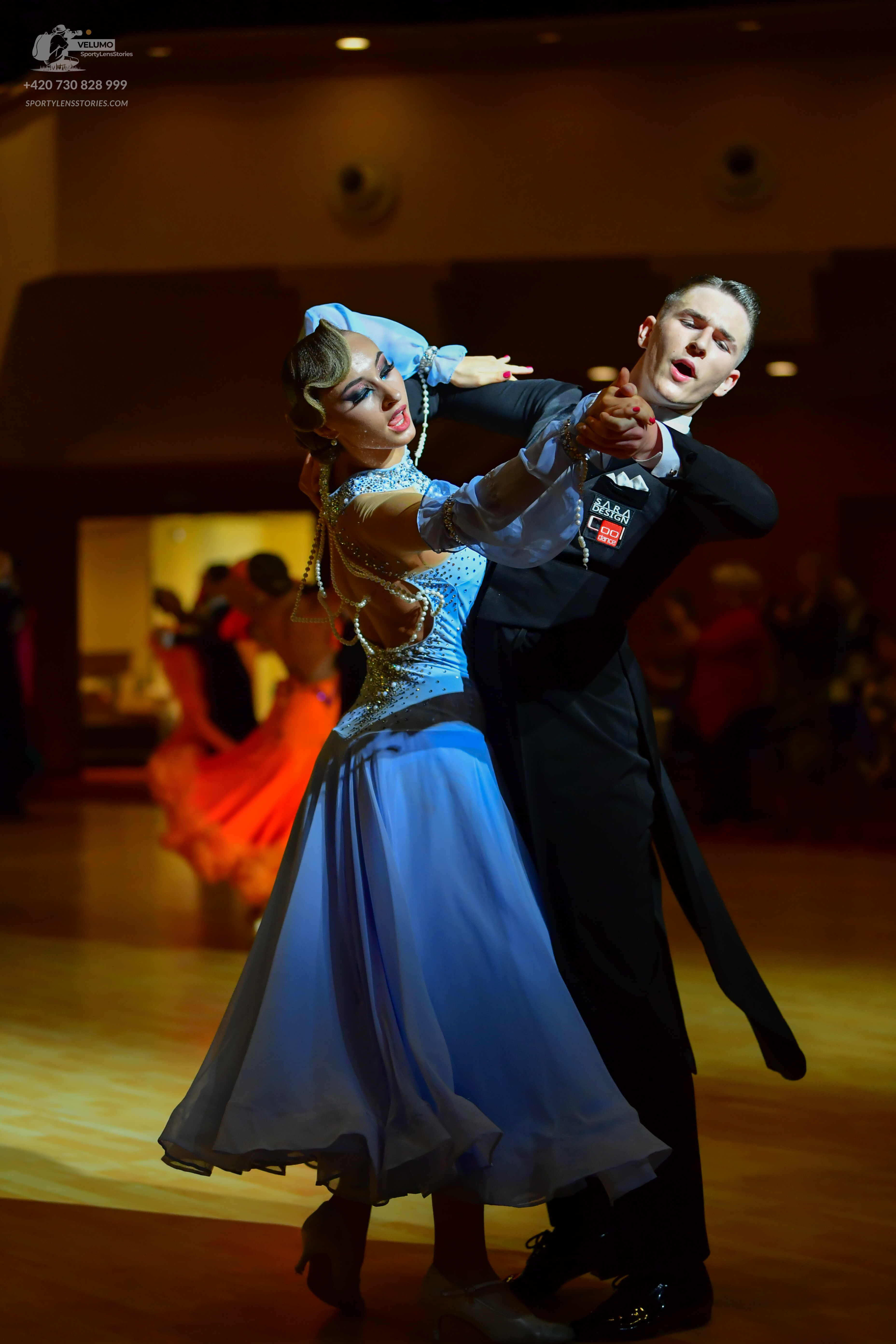 Dancesport competitor: Female dancer: light blue ballroom dress with a sequined and beaded bodice, shee