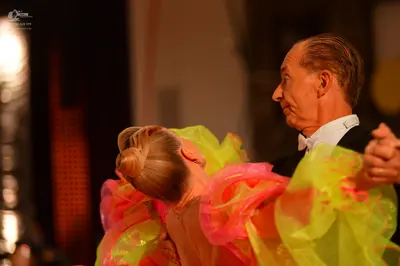 Dancesport competitor: Male dancer: black suit with a white shirt and a white bowtie