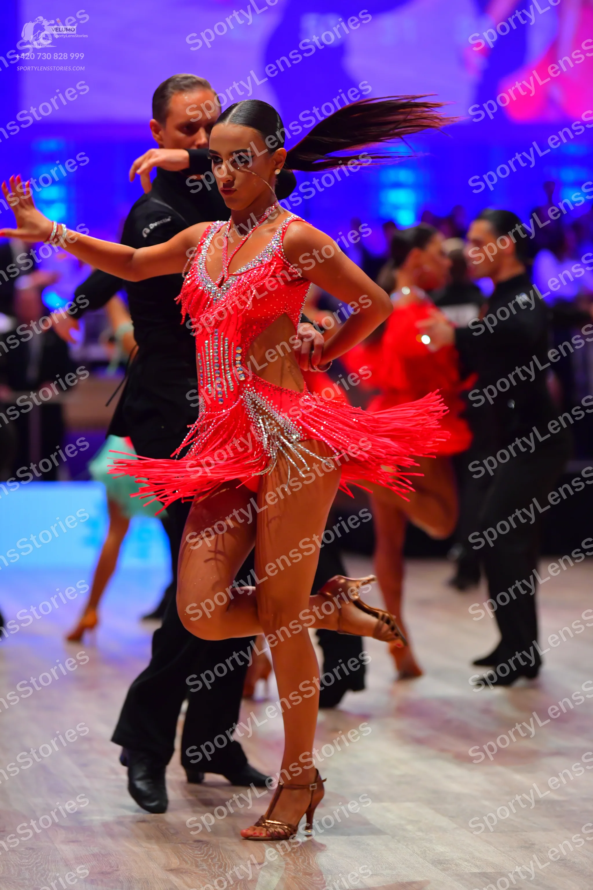 Dancesport competitor: Female dancer: red latin dress with fringe and silver sequins