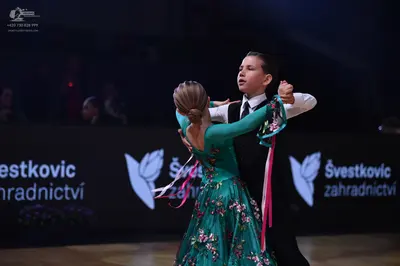 Dancesport competitor: Male dancer: white long-sleeved shirt with a black necktie and black trousers