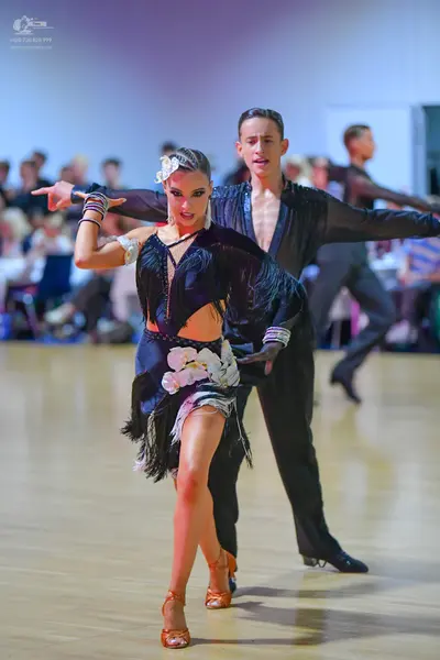 Dancesport competitor: Male dancer: black shirt with textured panels on the chest and black trousers