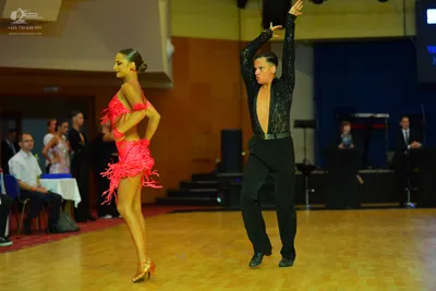 Dancesport competitor: Male dancer: black long-sleeved top and black trousers