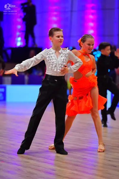 Dancesport competitor: Male dancer: white ruffled long-sleeved shirt and black trousers