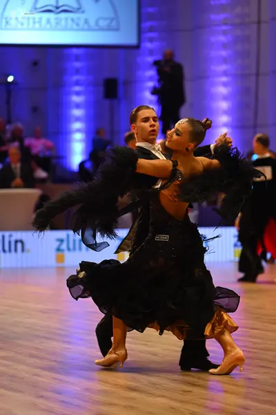 Dancesport competitor: Male dancer: black suit with a white shirt