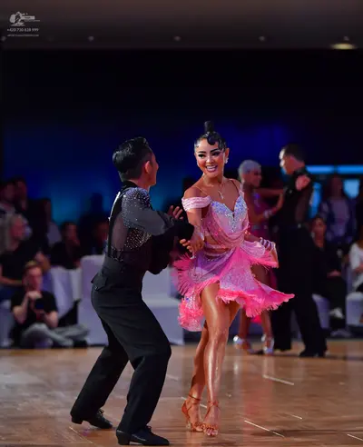 Dancesport competitor: Male dancer: black long-sleeved shirt with silver sequin embellishments on the s
