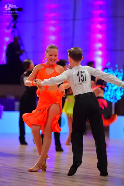 Dancesport competitor: Male dancer: white long-sleeved shirt and black trousers