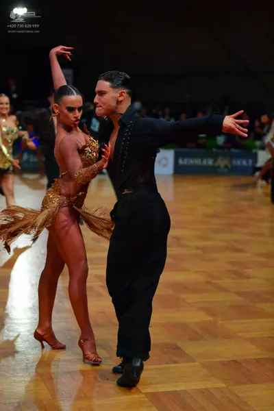 Dancesport competitor: Male dancer: black long-sleeved shirt and black trousers