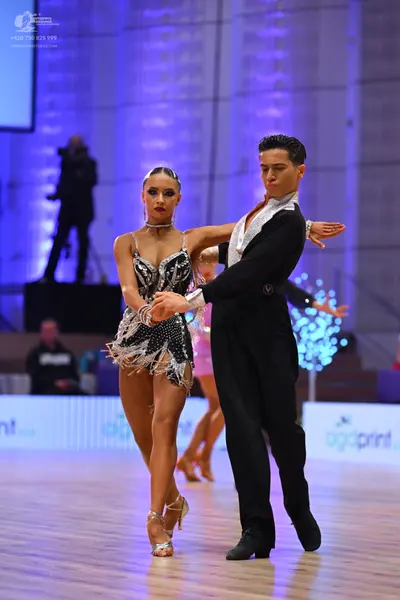 Dancesport competitor: Female dancer: black Latin dress with intricate silver/white sequin and beadwork