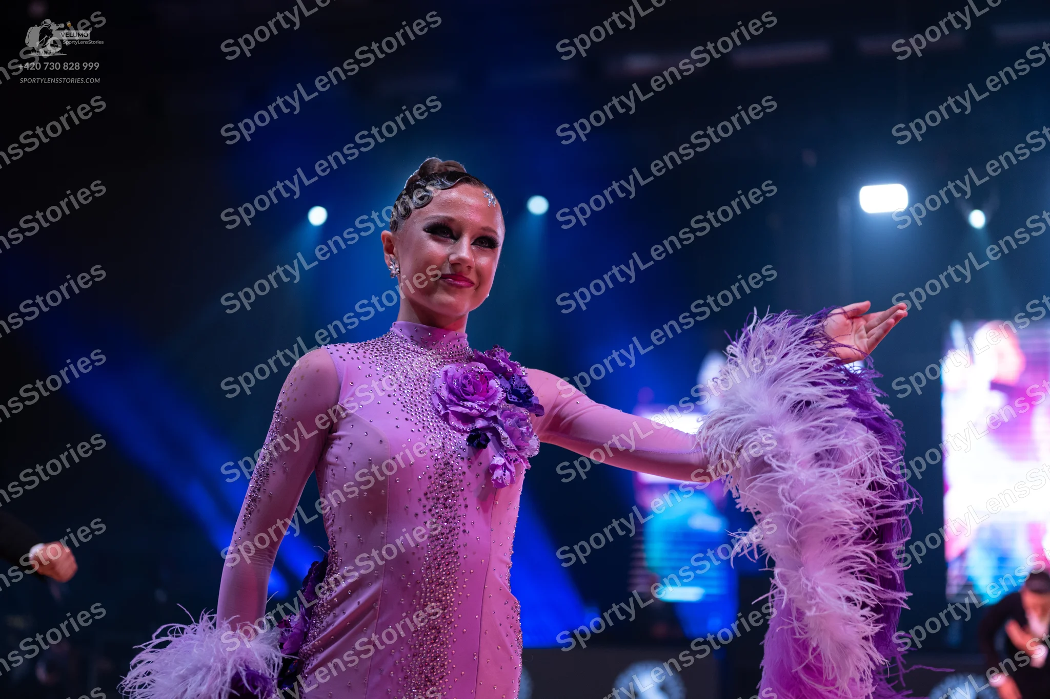 Dancesport competitor: Female dancer: lilac Latin dance dress with sequins, long sleeves, feathery trim