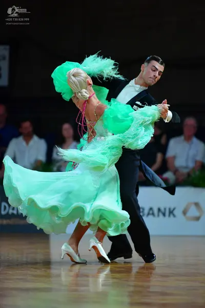 Dancesport competitor: Female dancer: mint green ruffled ballgown