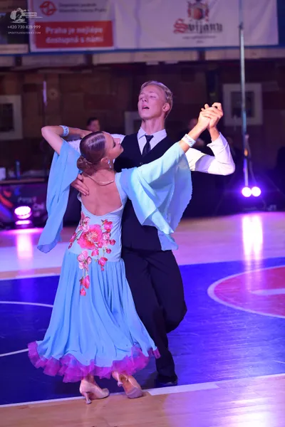 Dancesport competitor: Male dancer: black waistcoat, white long-sleeved shirt, black necktie, and black