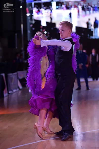 Dancesport competitor: Male dancer: white long-sleeved shirt, black waistcoat, and black trousers