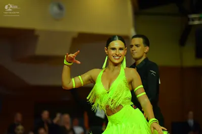 Dancesport competitor: Female dancer: bright neon yellow/lime green Latin dance dress with fringe, incl