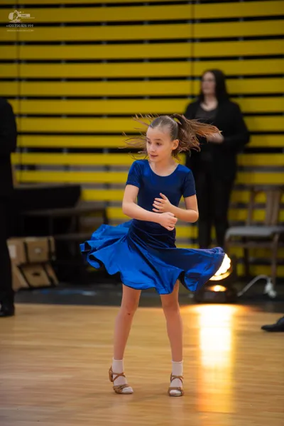 Dancesport competitor: ** Blue, shiny, possibly satin or lycra