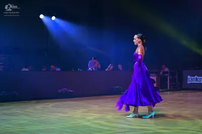 Dancesport competitor: Female dancer: purple satin ballgown