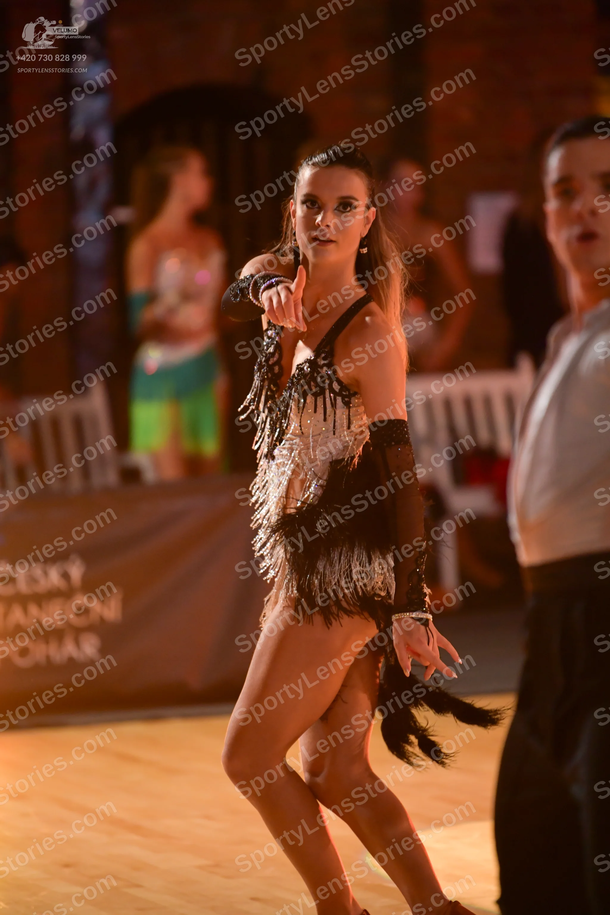 Dancesport competitor: Female dancer: black and silver latin dress with a sequined bodice and black fri