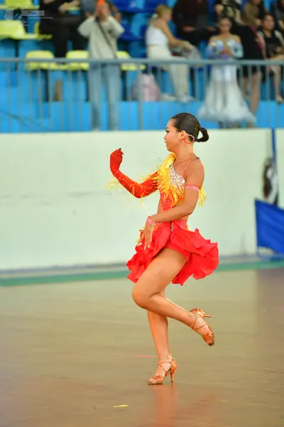 Dancesport competitor: Female:** Red Latin Dress