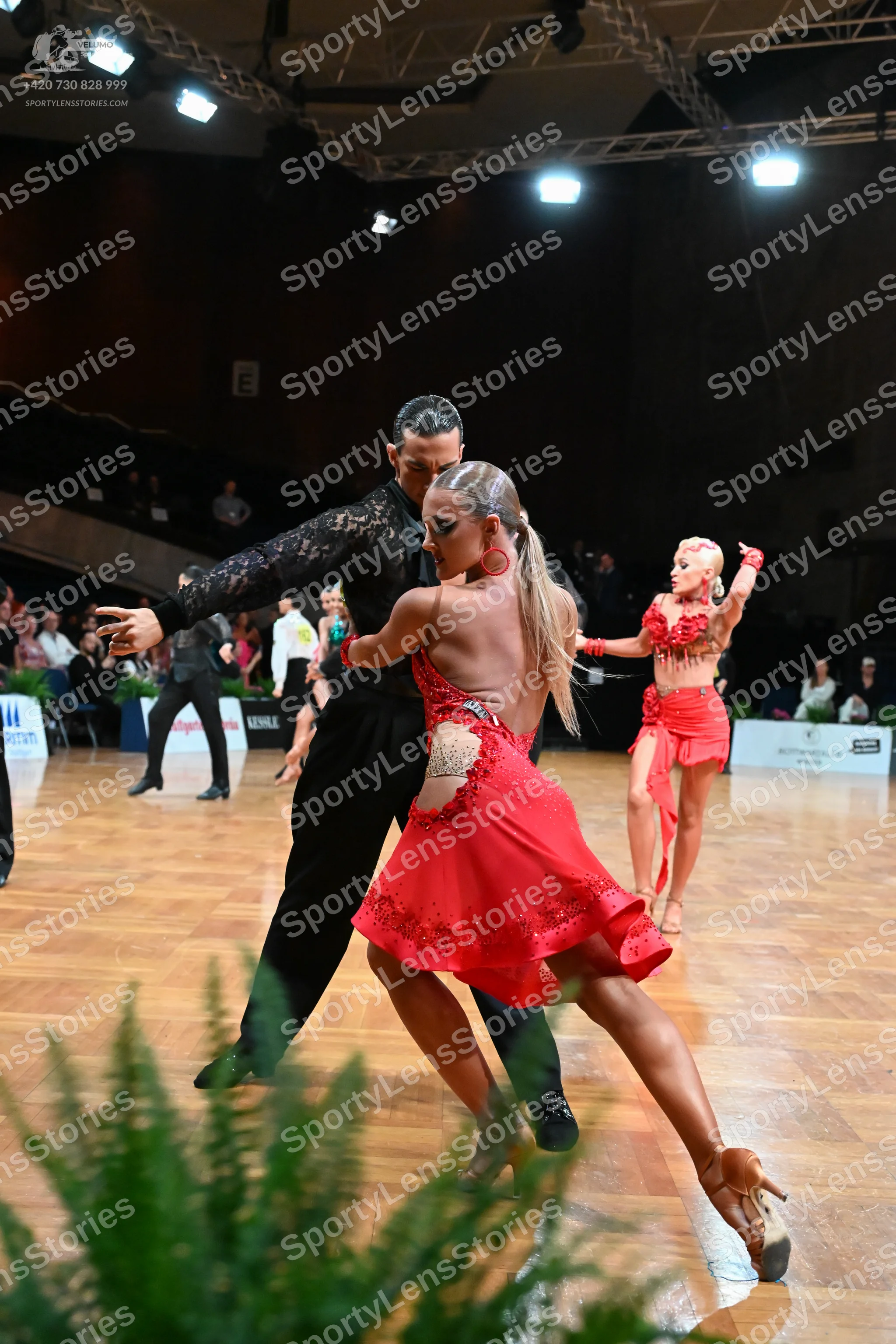 Dancesport competitor: Male dancer: black long-sleeved top with a textured pattern and black trousers