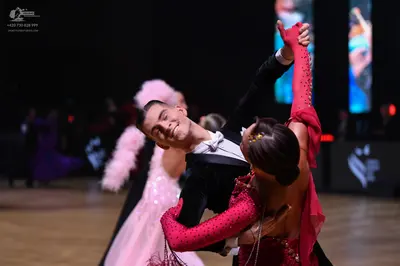 Dancesport competitor: Male dancer: black suit with white shirt and white bow tie