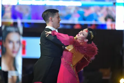 Dancesport competitor: Male dancer: black suit with a white shirt