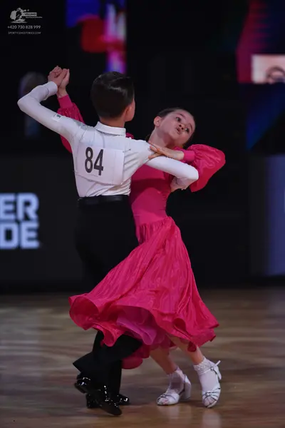 Dancesport competitor: Male dancer: white long-sleeved shirt and black trousers