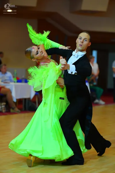 Dancesport competitor: Male dancer: black suit with a white shirt and white bowtie