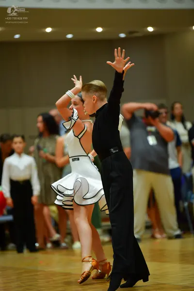 Dancesport competitor: Male dancer: black long-sleeved shirt and black trousers